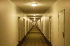 view-down-hotel-corridor-with-illuminated-lamps-on-royalty-free-image-1704470736.jpg